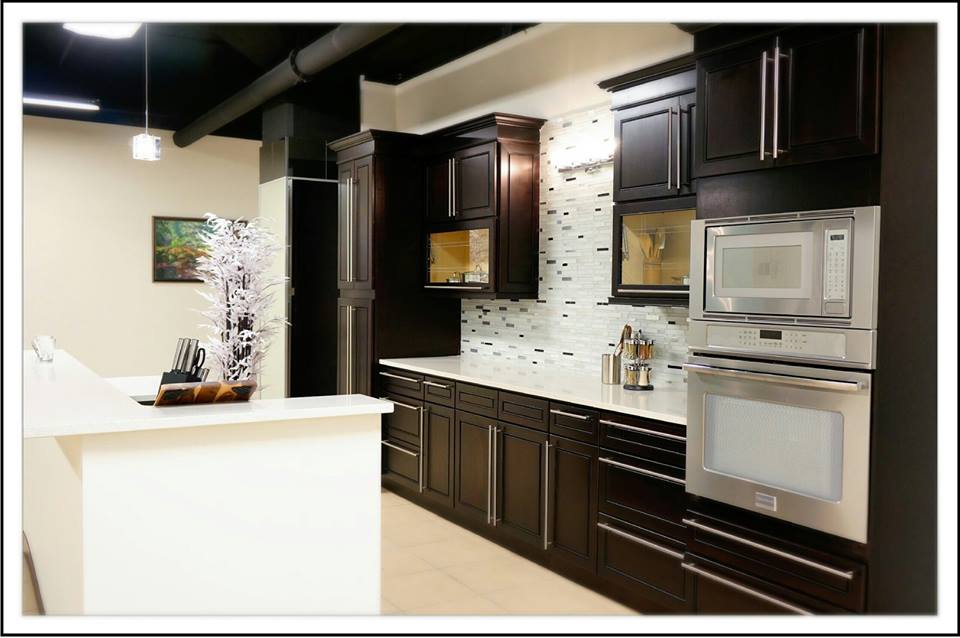 Dark espresso full-height cabinets with white countertops — showroom vignette